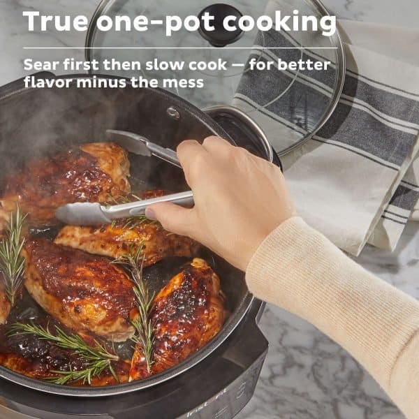 Searing chicken thighs in a slow cooker with fresh rosemary for enhanced flavor and minimal mess, demonstrating true one-pot cooking techniques.